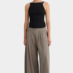 Model wearing the black Kowtow Low Back Cami with taupe wide leg trousers, full front view at YUCCA Denver.