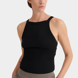 Close view of the black ribbed Kowtow Low Back Cami showing its high neckline and wide straps.