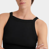 Three-quarter front view of the black Kowtow Low Back Cami showing its close fit and ribbed texture.
