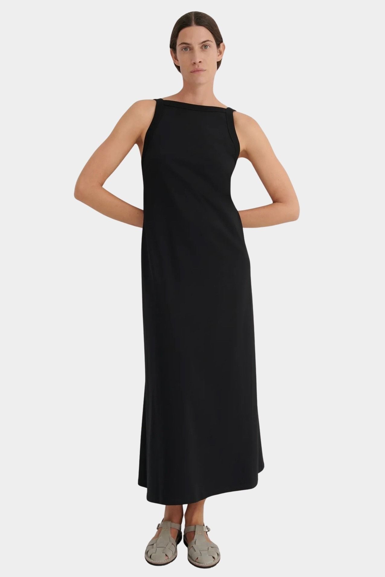 Front view of the black Low Back Dress with a wide neckline and flowing ankle length skirt
