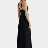 Kowtow Low Back Dress in black worn with black lace up shoes, back view showing low open back