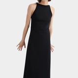 Kowtow Low Back Dress in black worn with black lace up shoes, angled front view