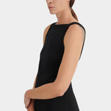Side detail of the black Kowtow Low Back Dress showing its wide neckline and sleeveless bodice at YUCCA Denver