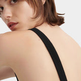 Kowtow Low Back Dress in black close up showing open low back and wide shoulder straps