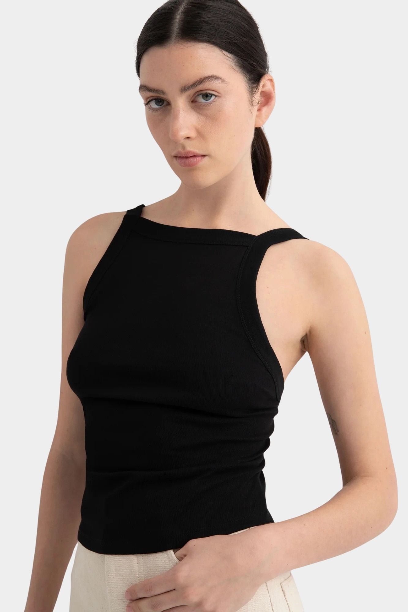 Kowtow Low Back Tank in black, close front view showing high neckline and fitted silhouette