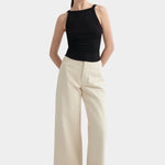 Kowtow Low Back Tank in black worn with cream wide leg trousers, front view
