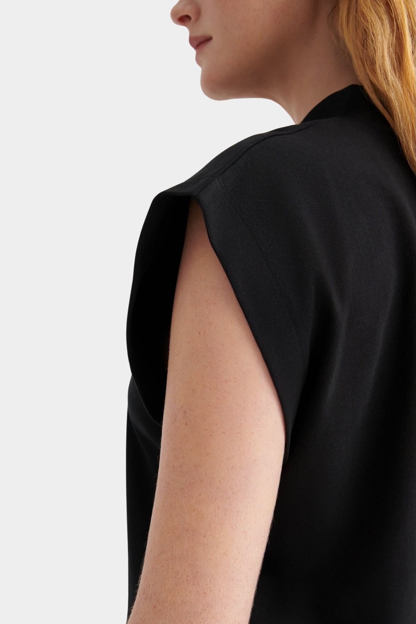 Kowtow Method Tank in black close up showing high neckline and structured cap sleeve