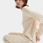 Kowtow chalk patchwork jumper textured knit sweater side seated view