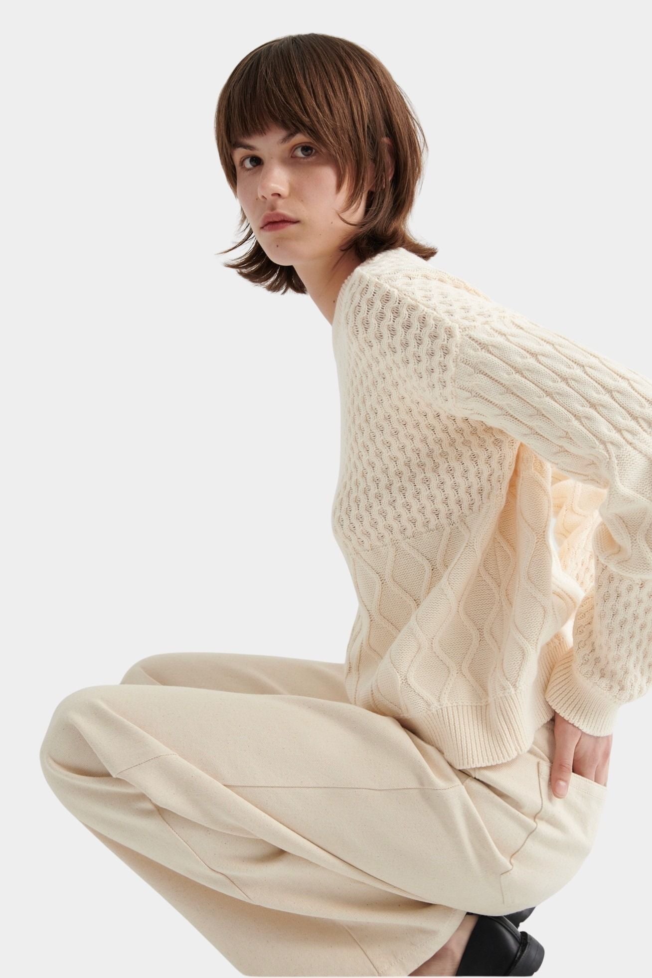 Kowtow chalk patchwork jumper textured knit sweater side seated view