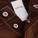 Kowtow Unity Jeans in brown denim close up interior label and metal button detail