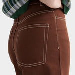 Kowtow Unity Jeans in brown denim close up back pocket detail with contrast stitching