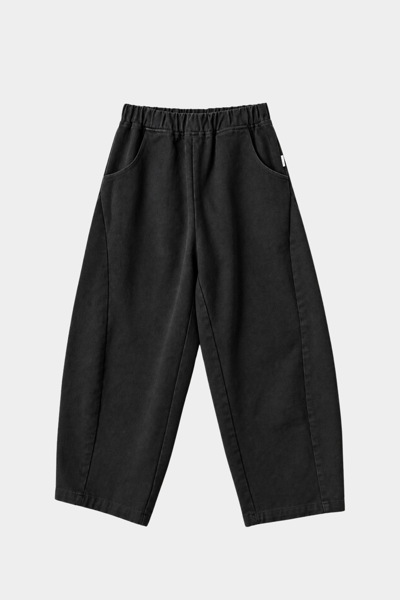 Le Bon Shoppe Arc Pants in black canvas flat lay showing elastic waistband, curved legs and oversized pockets. YUCCA Denver