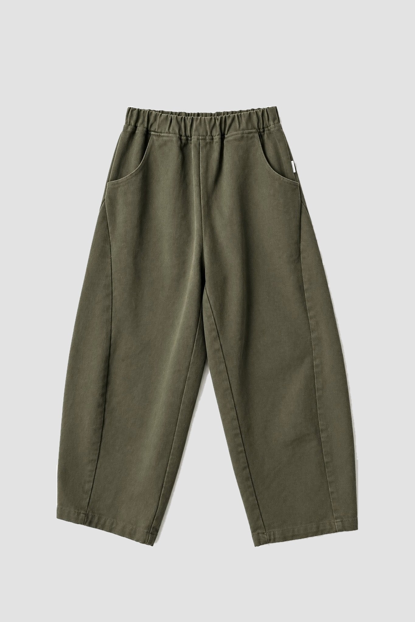 Le Bon Shoppe Arc Pants in olive flat lay showing elastic waistband, oversized front pockets and curved leg silhouette. Available at YUCCA Denver.