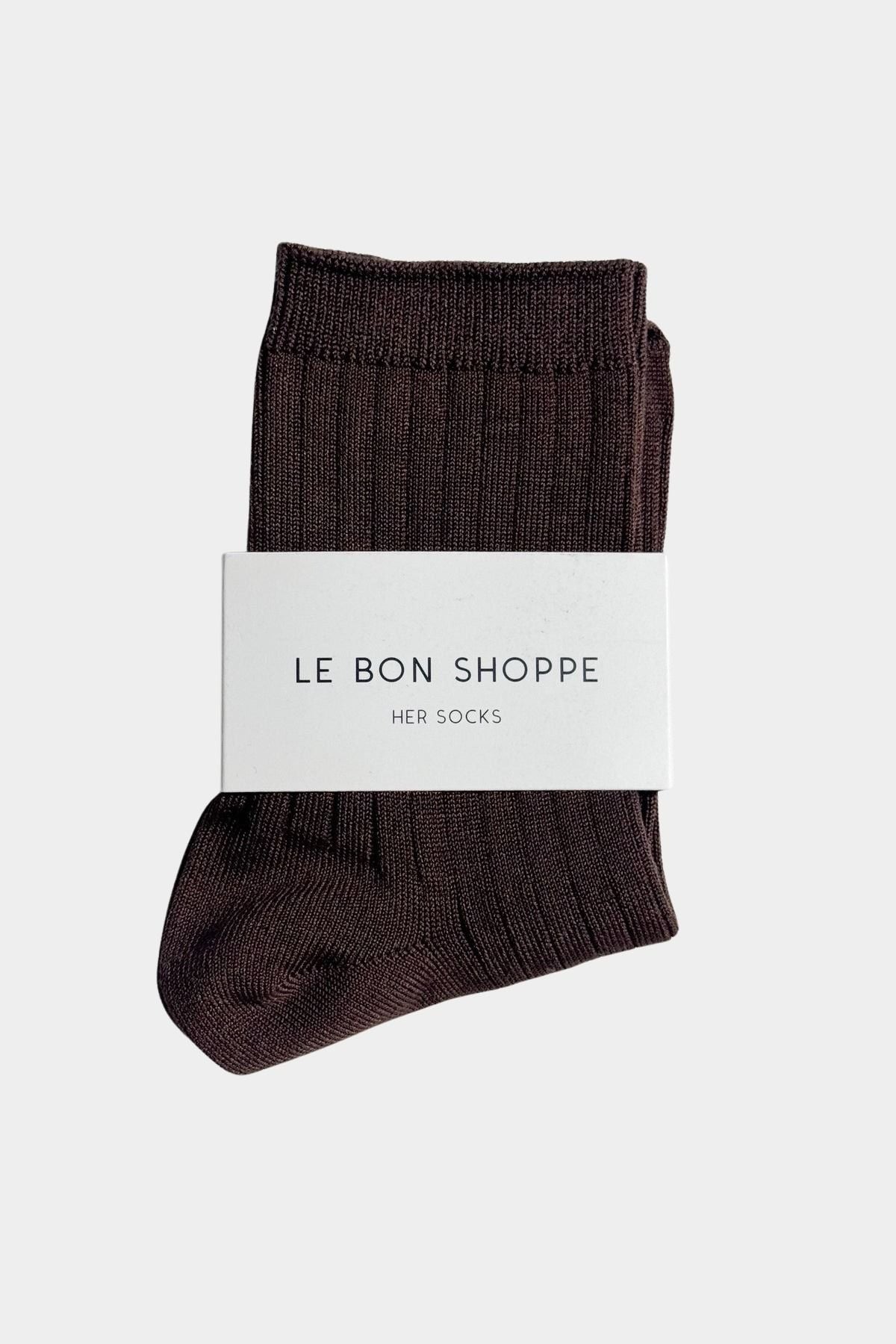 Espresso brown Le Bon Shoppe Her Socks folded with branded paper band on white fabric in direct sunlight