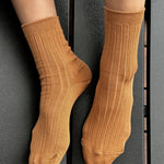Peanut Butter ribbed cotton socks worn without shoes, showing the fine knit texture, heel and comfortable cuff