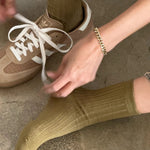 Pesto ribbed cotton socks styled with tan Adidas sneakers, white laces and a gold chain bracelet