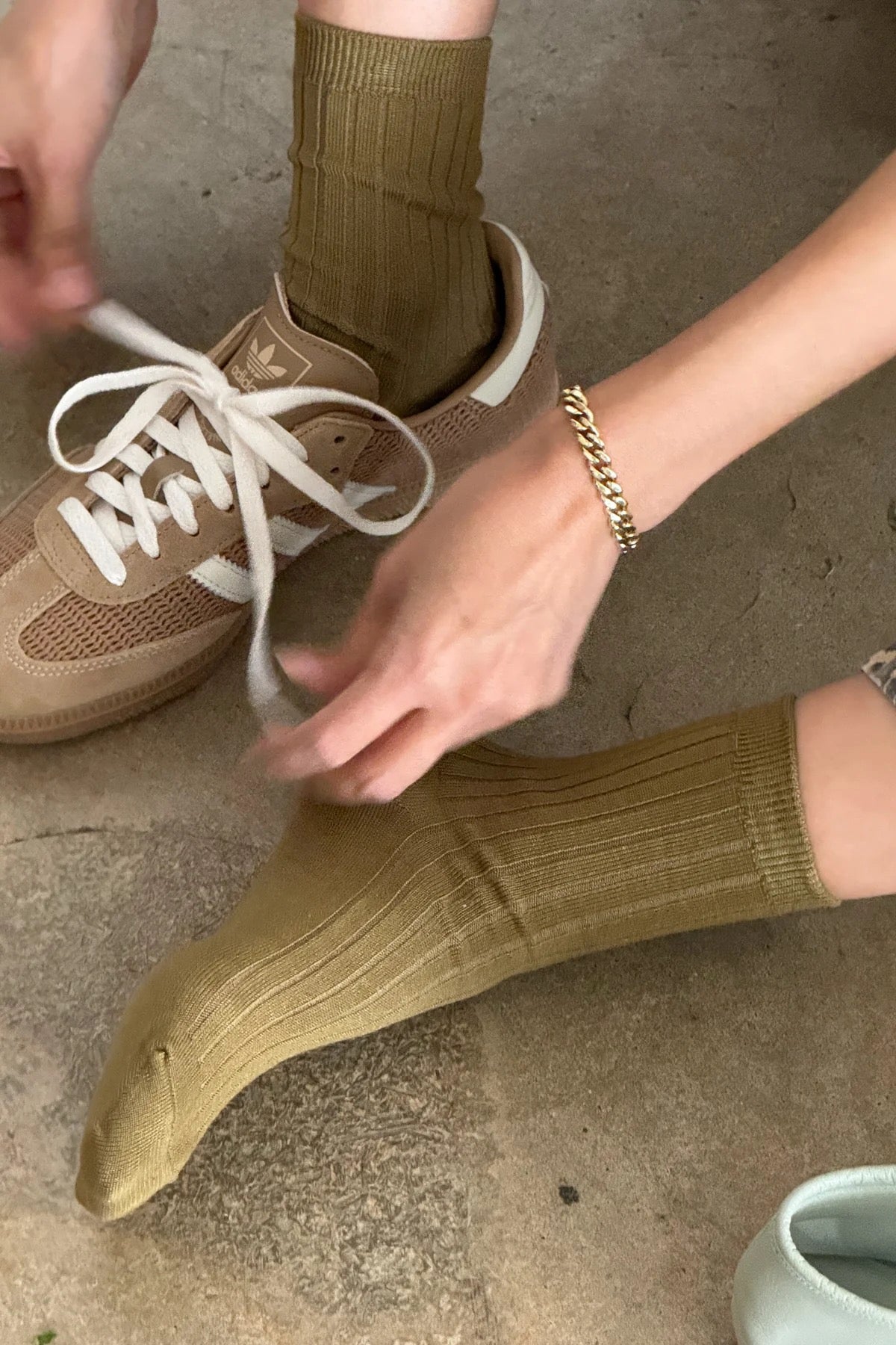 Pesto ribbed cotton socks styled with tan Adidas sneakers, white laces and a gold chain bracelet