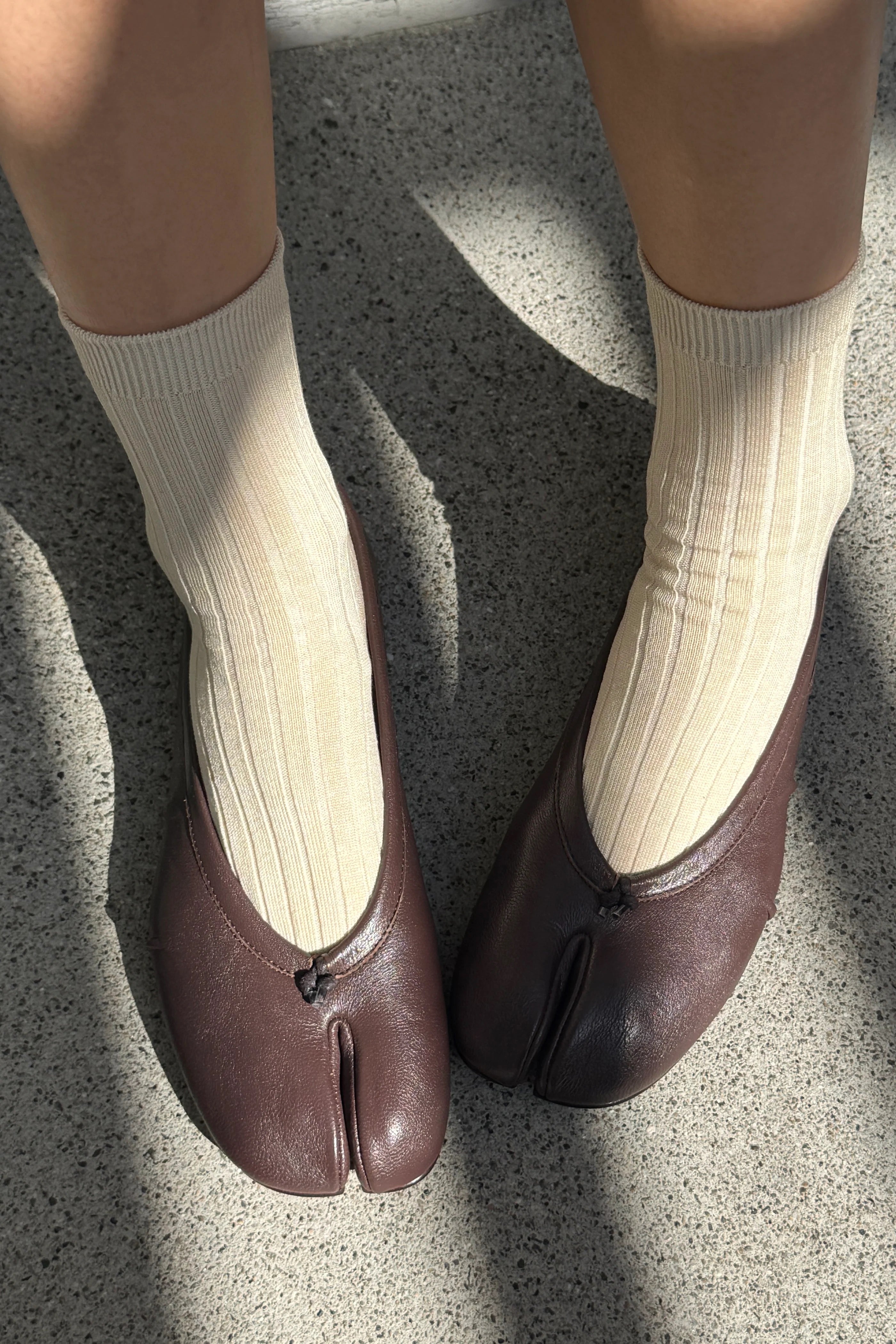 Porcelain cotton blend ribbed socks shown on feet with brown leather flats at YUCCA Denver
