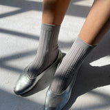 Close-up of Le Bon Shoppe Her Socks in Stone worn with silver ballet flats, highlighting ribbed texture and fit.