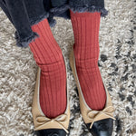 Terracotta ribbed cotton socks styled with frayed dark denim and two tone ballet flats