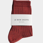Folded Terracotta Her Socks by Le Bon Shoppe with branded paper band on white fabric