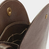 Open Chaga Eggi bag showing its interior leather card pockets, divided compartments, and brass snap