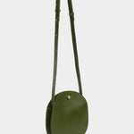Eggi leather crossbody bag in Olive with its adjustable strap extended, offered at YUCCA in Denver