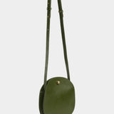 Eggi leather crossbody bag in Olive with its adjustable strap extended, offered at YUCCA in Denver