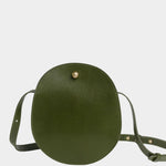 Front view of the Olive Eggi bag with its long leather strap arranged around the base