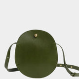 Front view of the Olive Eggi bag with its long leather strap arranged around the base