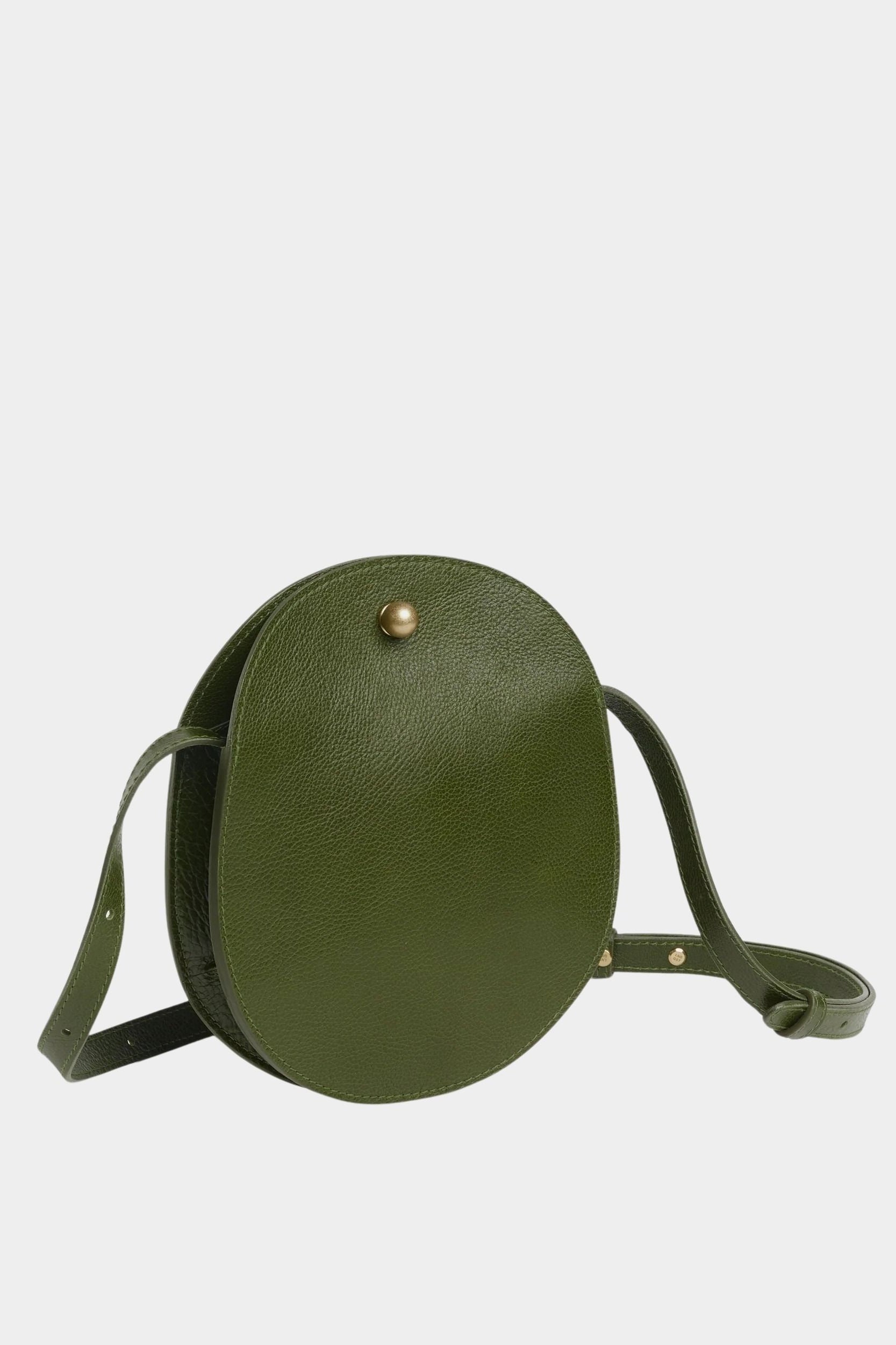 Angled view of the Olive Eggi leather bag showing its side gusset and adjustable shoulder strap