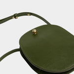 LINDQUIST Eggi bag in Olive laid flat, showing its oval leather body, side gusset, and adjustable strap