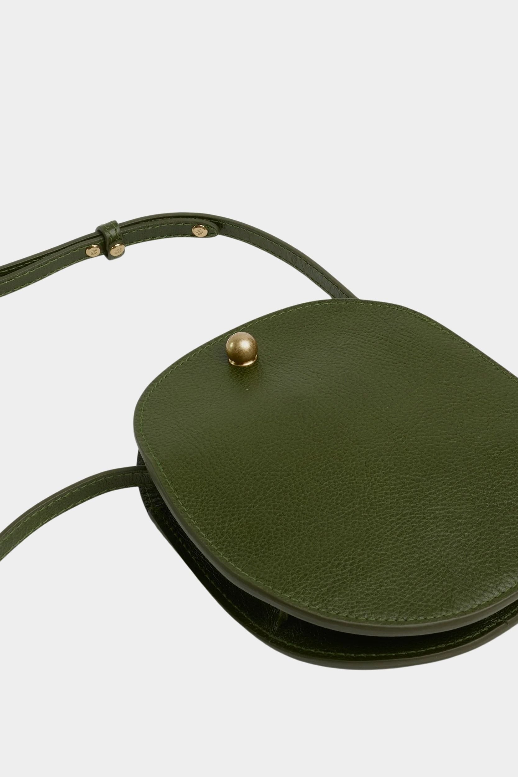 LINDQUIST Eggi bag in Olive laid flat, showing its oval leather body, side gusset, and adjustable strap