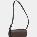 Angled view of the Chaga Mezzo shoulder bag showing its rounded flap and graduated side gusset