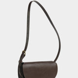 Angled view of the Chaga Mezzo shoulder bag showing its rounded flap and graduated side gusset