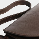Detail of the Chaga Mezzo bag’s curved leather flap, side gusset, and adjustable strap