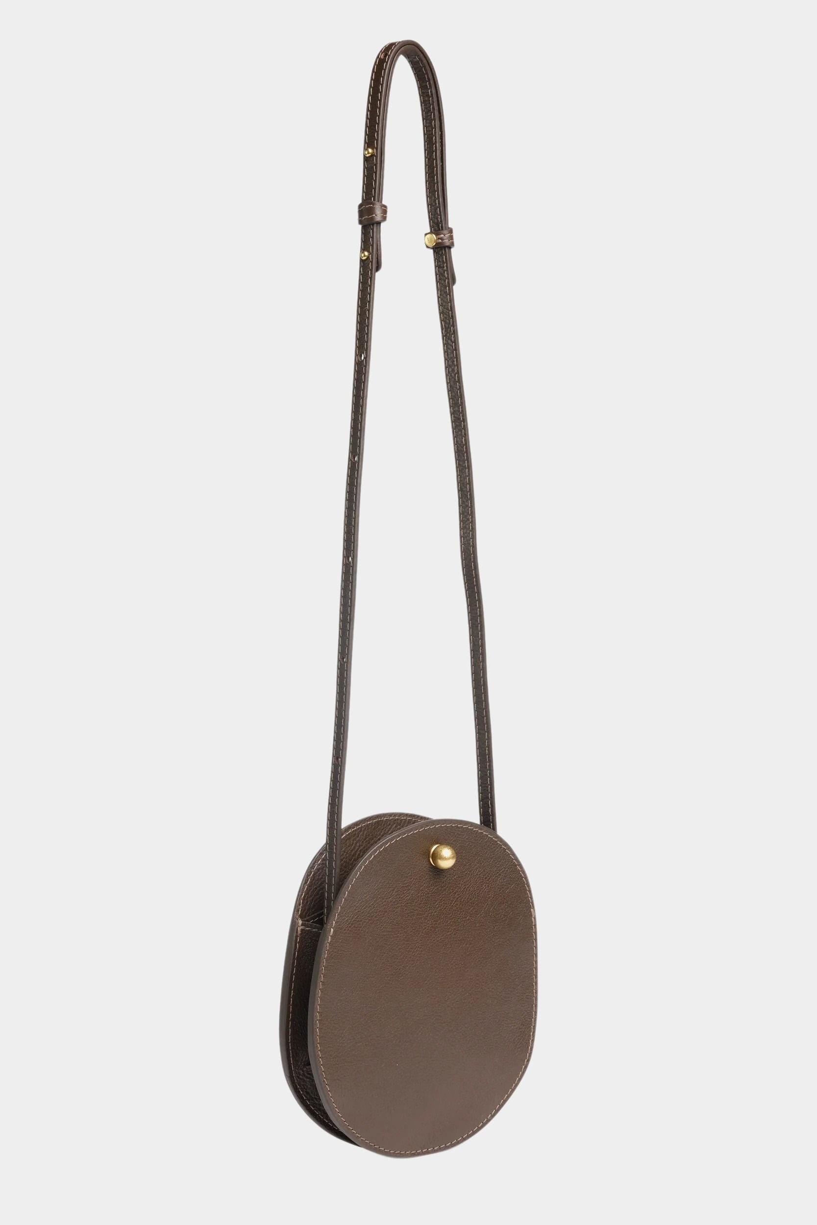 Mini Eggi leather crossbody bag in Chaga with its adjustable strap extended, offered at YUCCA in Denver