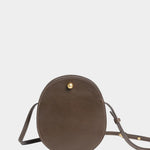 Front view of the Chaga Mini Eggi bag with its adjustable leather strap arranged around the base