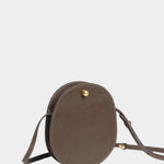 Angled view of the LINDQUIST Mini Eggi bag in Chaga showing its compact profile and brass closure