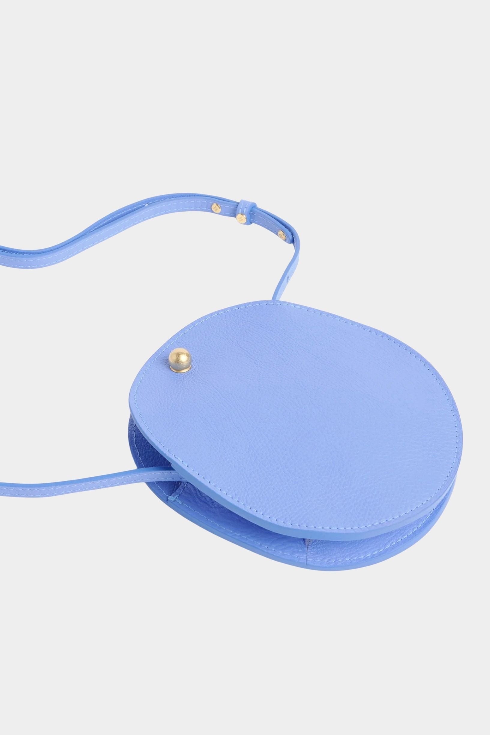 Lindquist Mini Eggi periwinkle leather bag angled view with adjustable strap detail