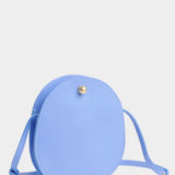 Lindquist Mini Eggi periwinkle circular leather crossbody front view with brass snap