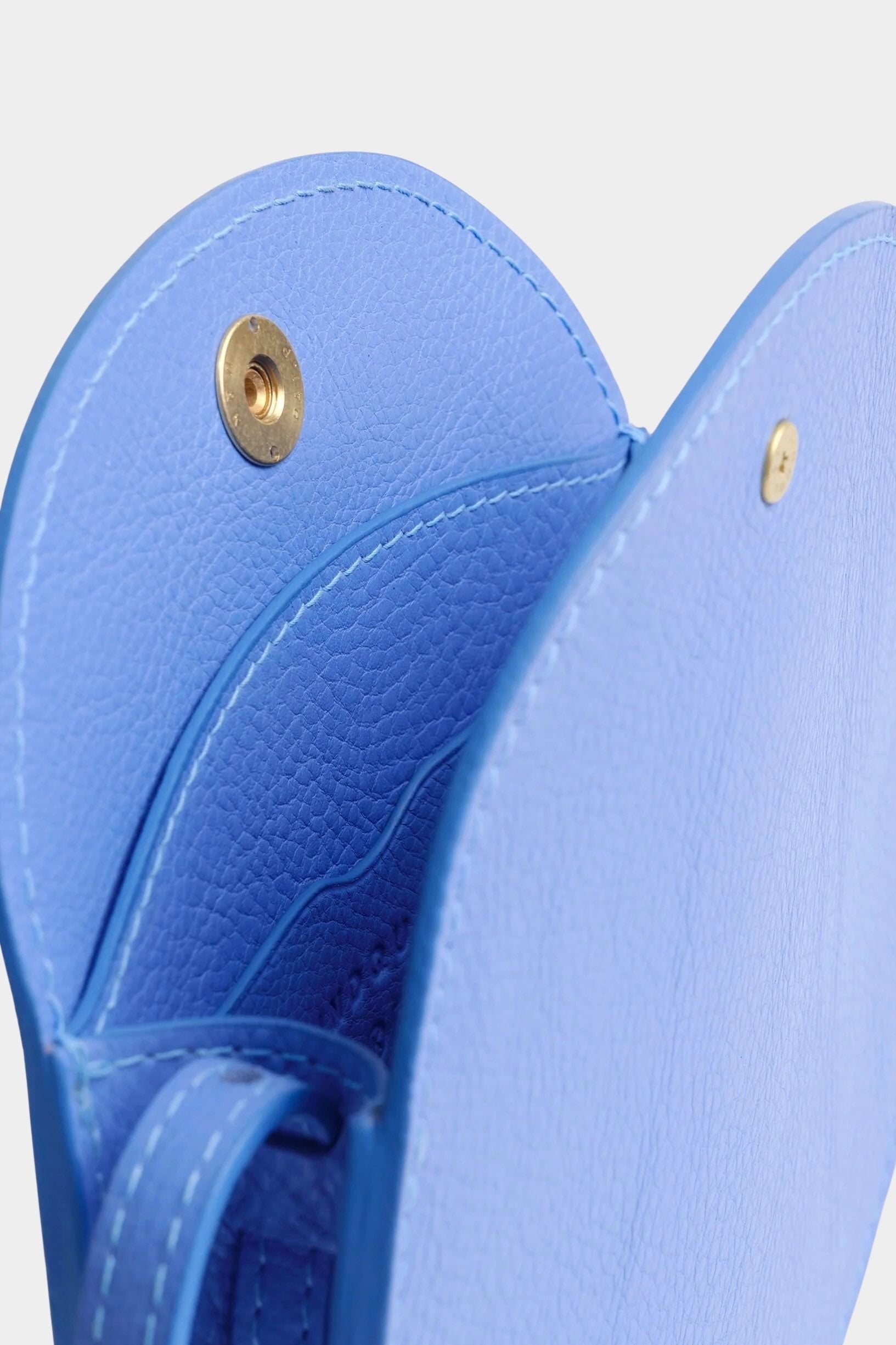 Lindquist Mini Eggi periwinkle leather bag interior view with snap closure and compartment