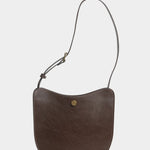 Chaga Savoie leather shoulder bag with a shortened strap and brass adjustment hardware