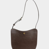 Chaga Savoie leather shoulder bag with a shortened strap and brass adjustment hardware