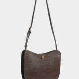 LINDQUIST Savoie bag in Chaga shown with its leather strap extended for crossbody wear