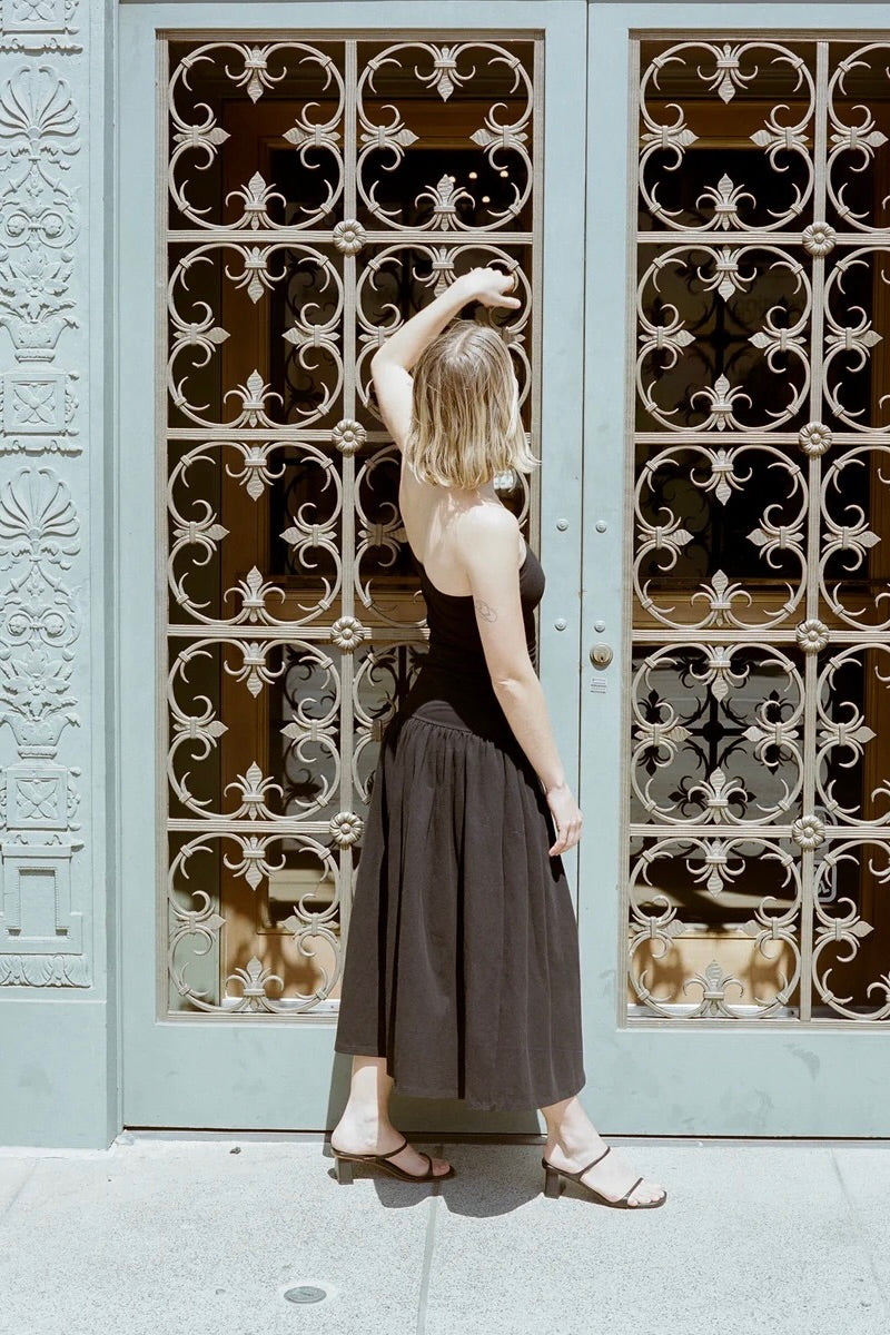 LOQ Gael black leather heeled sandal worn with black strapless midi dress back view