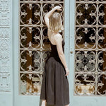 LOQ Gael black leather heeled sandal worn with black strapless midi dress back view