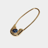 Angled close view of 14k gold Cirque Safety Pin Earring with round blue sapphire