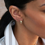 Model wearing 14K gold pavé diamond bar stud earring.