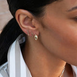 Model wearing 14K gold pavé diamond bar stud earring.